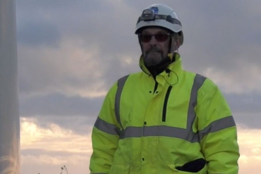 Man in front of wind turbine